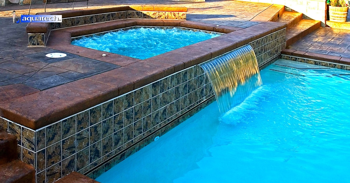 Luxury backyard inground pool with lounge seating at sunset