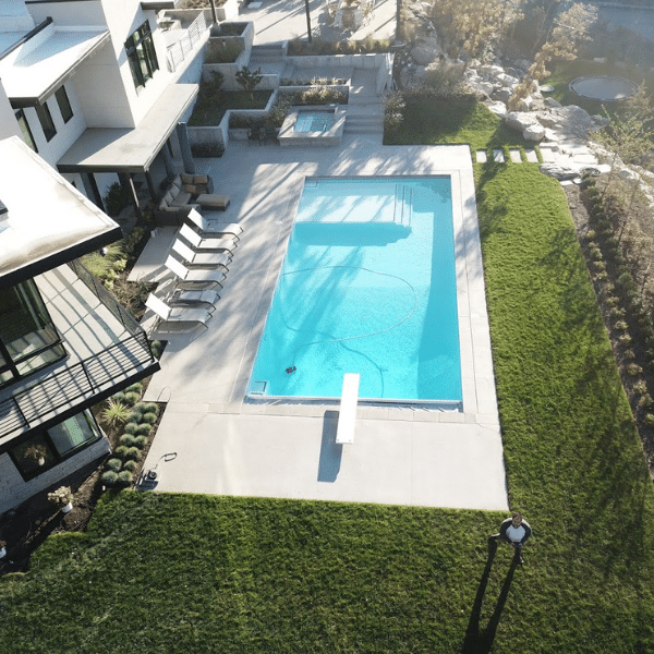 Custom-designed backyard pool with deck and modern landscaping