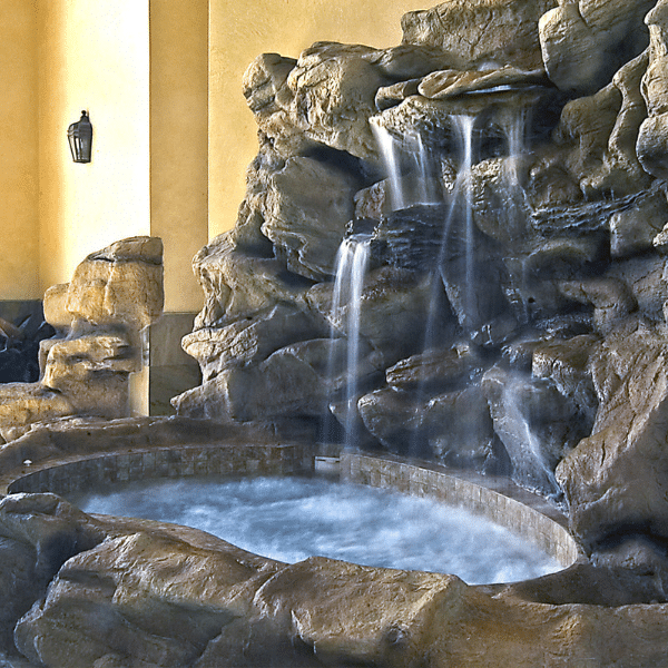 Custom pool with waterfall, spa, and LED lighting