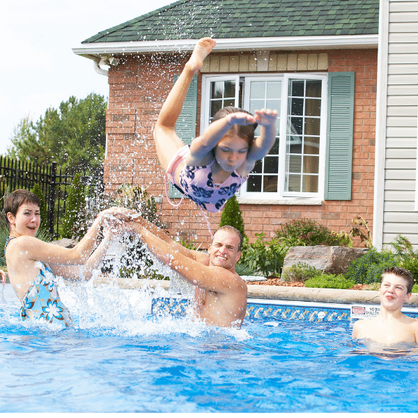 Family enjoying a clean backyard pool thanks to efficient pump system